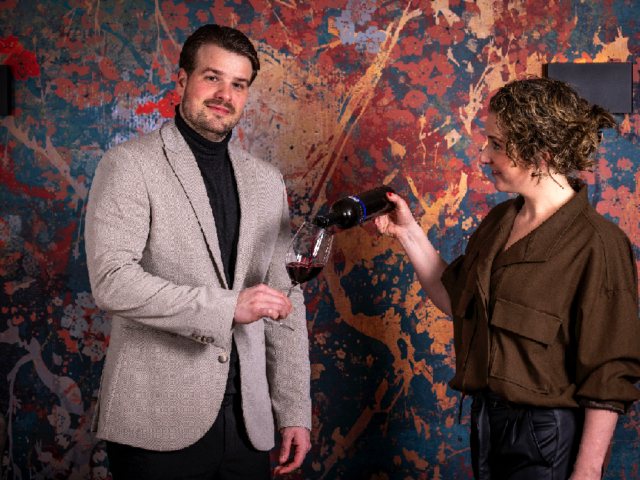 Afbeelding wijn inschenken en werknemers restaurant De Burgemeester